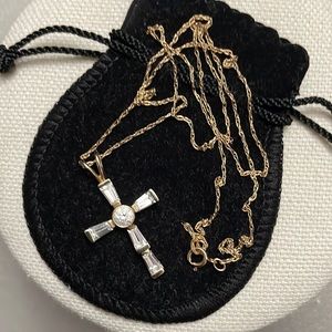 Cross pendant in 10k yellow gold with cubic zirconia stones.